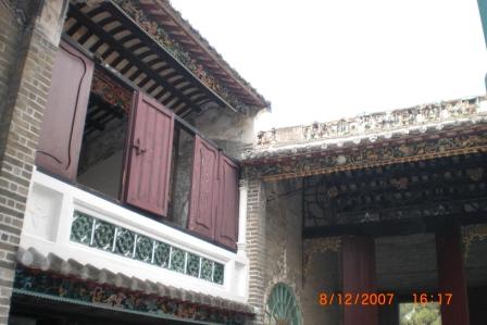 The deco on the outer wall of the building above the courtyard