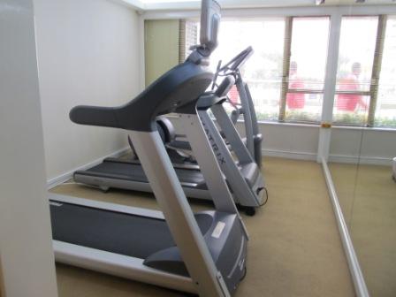 A corner of the gym.  There are 2 more machines and 2 weight-lifting systems