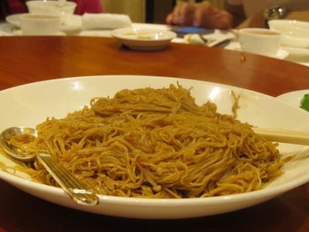 Stir-fried noodles with Japanese enoki mushrooms and soy sauce in Fook Lam Moon Restaurant