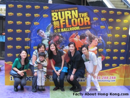 My family and I standing in front of the billboard of the "Burn The Floor" Dance Show in the Hong Kong Academy for Performing Arts