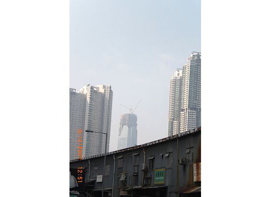 The contrast between the old building of the mom and pop shipyards and the new skyscrapers 