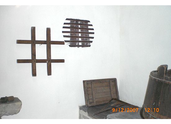 Next to the stove, there are some basic kitchen tools on the wall.