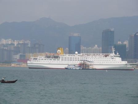 I LOVE this picture. See the fisherman at the bottom left corner of the picture...Behind him, it is the humongous cruise liner.  What a picture, huh?