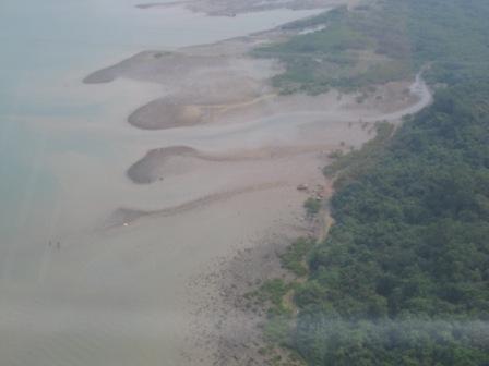 Looking down is a group of villagers fishing for clams in their traditional Chinese outfit and baskets on hand