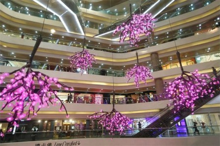 The peach blossom, one of the most popular Chinese New Year flowers, hanging upside down in the Times Square, Causeway Bay, Hong Kong