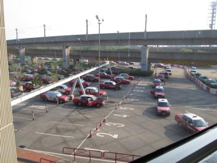 These taxis are waiting for their customers at the Hong Kong International Airport.  See the right corner, there is a line of green taxis for going to the New Territories.  The red ones definitely dominate the market