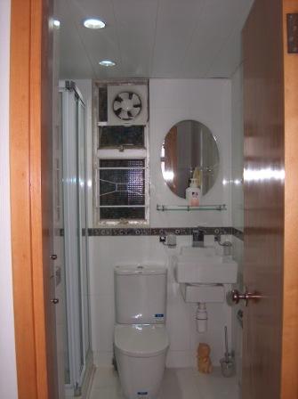 This is the bathroom. On the left hand side, it was a built-in cabinet. A space for washing machine and dryer on top of each other. Then, a stand-up shower.