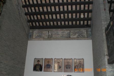 Chinese have the tradition to hang up pictures of their ancestors and worship them on a daily basis